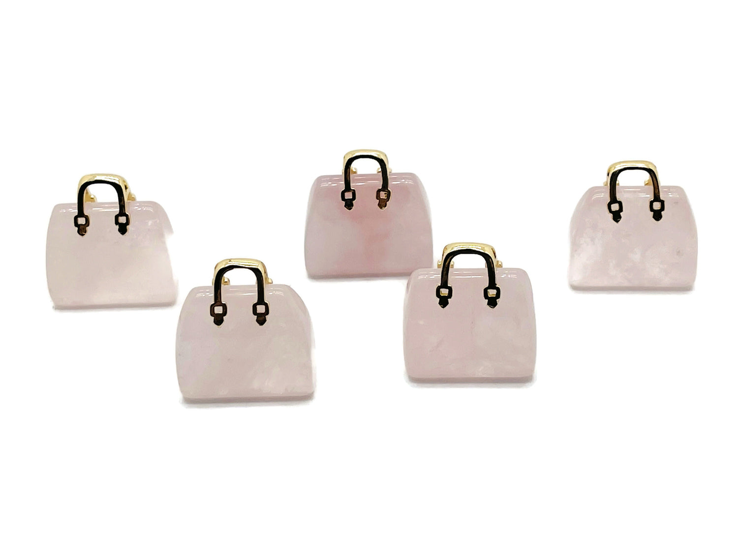 Rose quartz crystal gemstone carved as a handbag pendant, featuring detailed carvings and a polished finish.