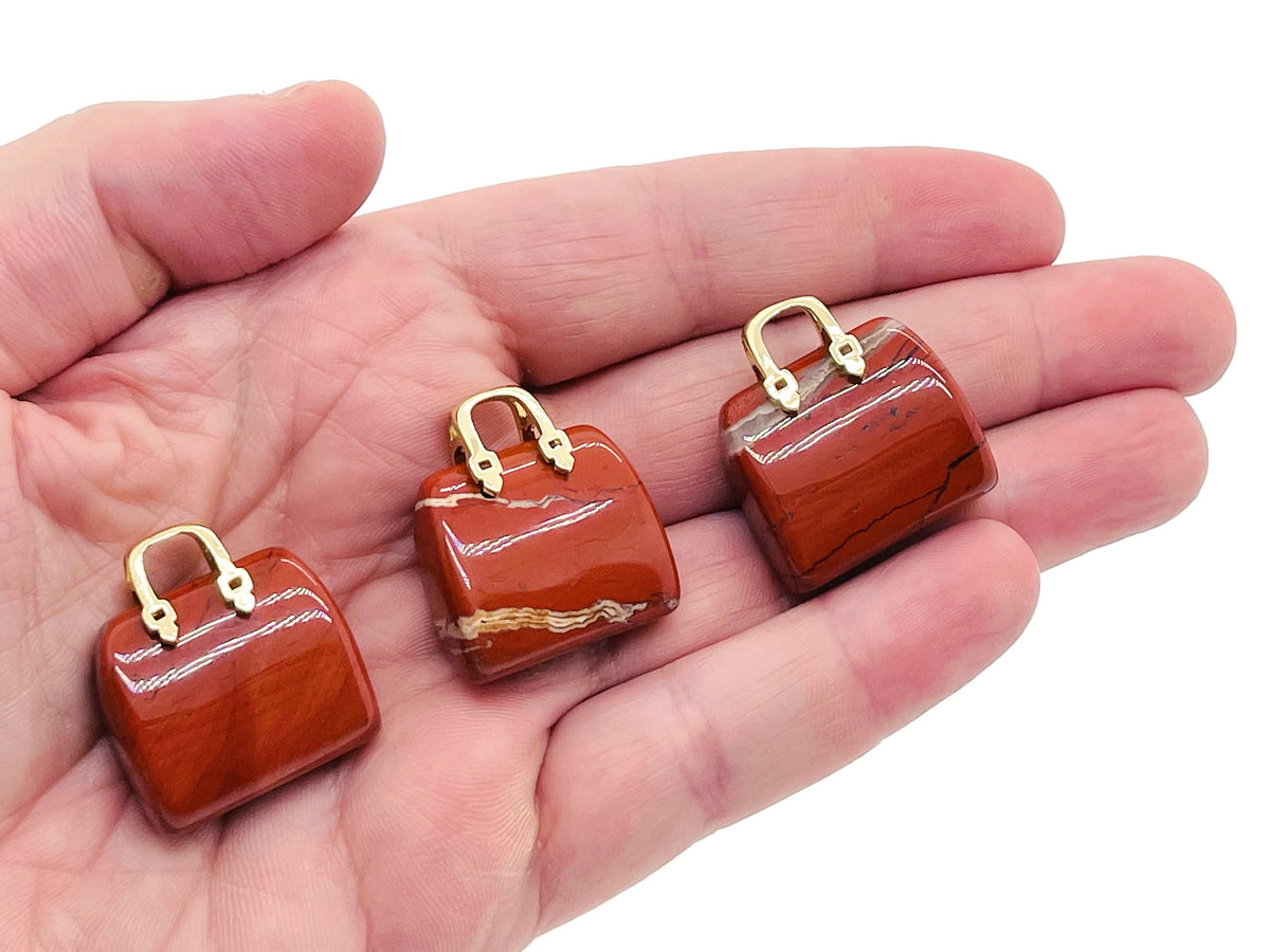 Red Jasper crystal handbag pendant carved from gemstone, featuring a detailed purse design, perfect as a unique jewelry accessory.