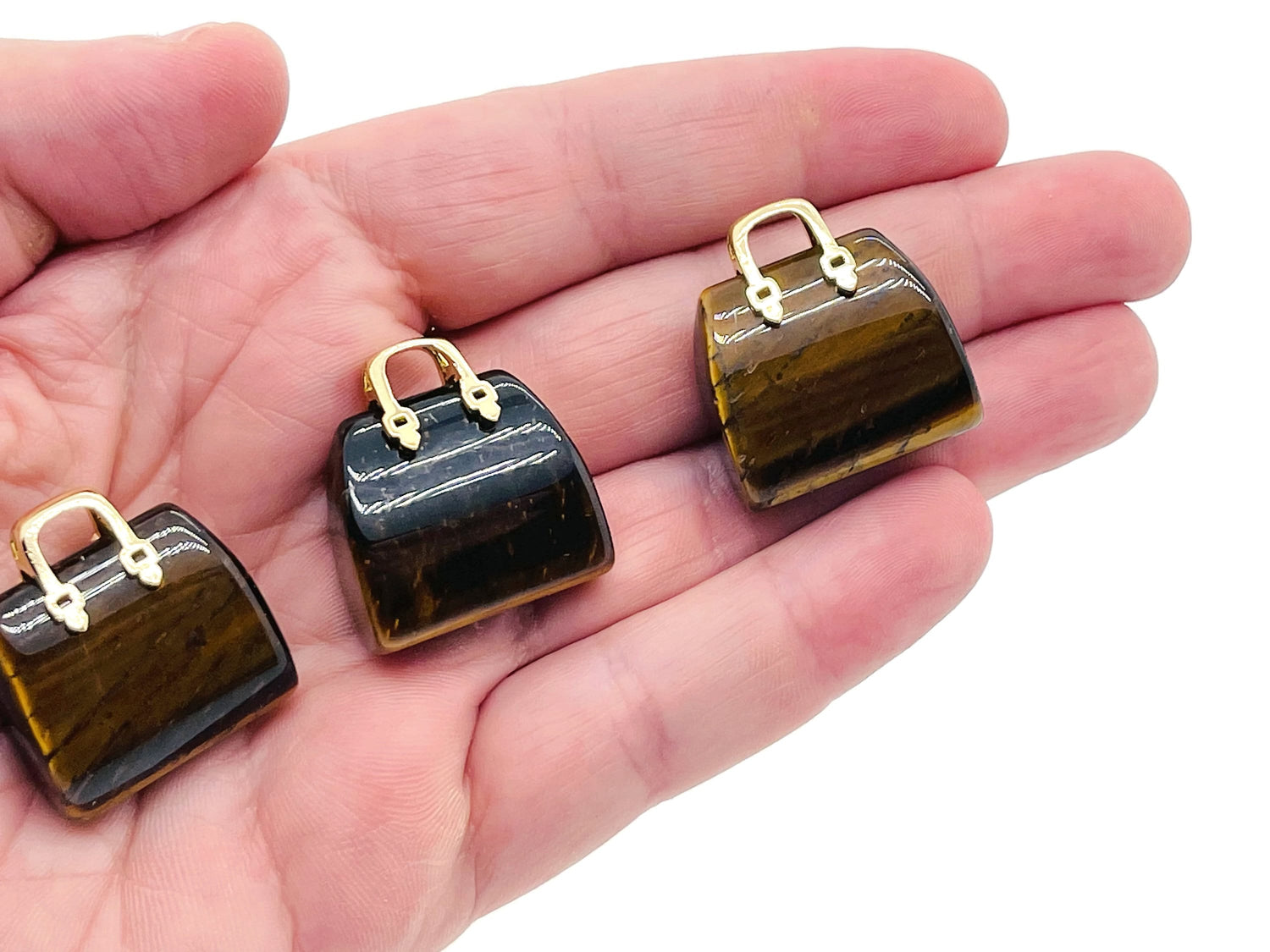 Tiger Eye crystal purse carving gemstone with handbag pendant design, showcasing detailed craftsmanship and rich golden-brown hues.