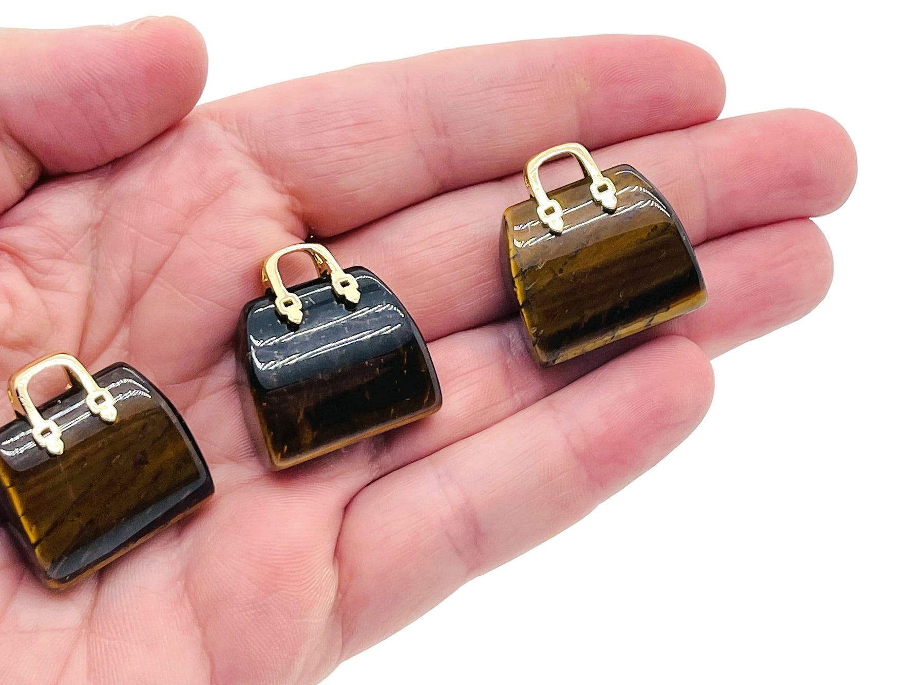 Tiger Eye crystal purse carving gemstone with handbag pendant design, showcasing detailed craftsmanship and rich golden-brown hues.