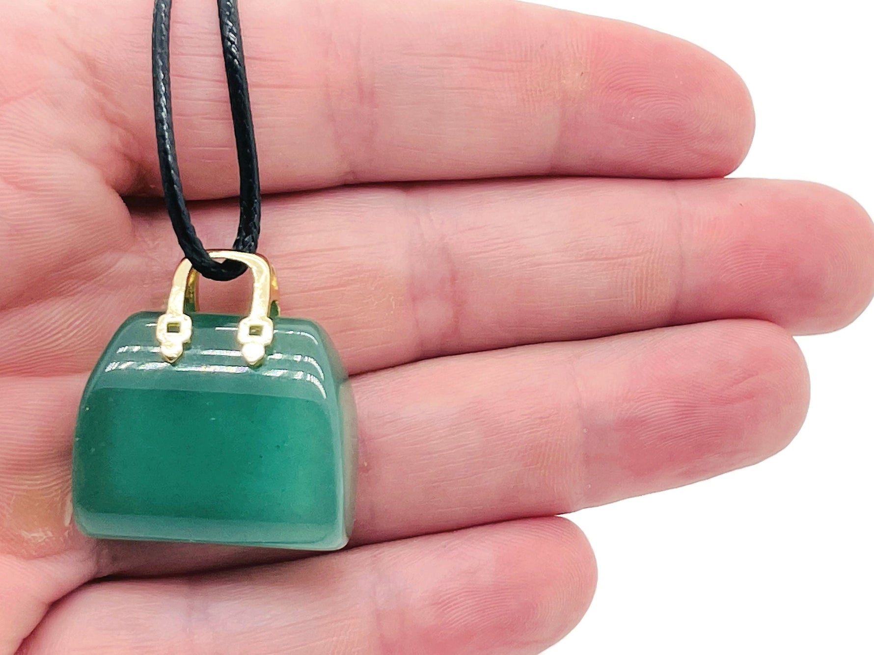 Aventurine crystal handbag pendant with carved gemstone design, featuring a polished green aventurine stone for jewelry or accessories.