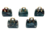 African Bloodstone crystal purse carving pendant featuring detailed gemstone craftsmanship, ideal for jewelry or handbag embellishments.