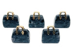 Larvikite crystal purse carving gemstone used as a handbag pendant, showcasing detailed craftsmanship and natural stone patterns.