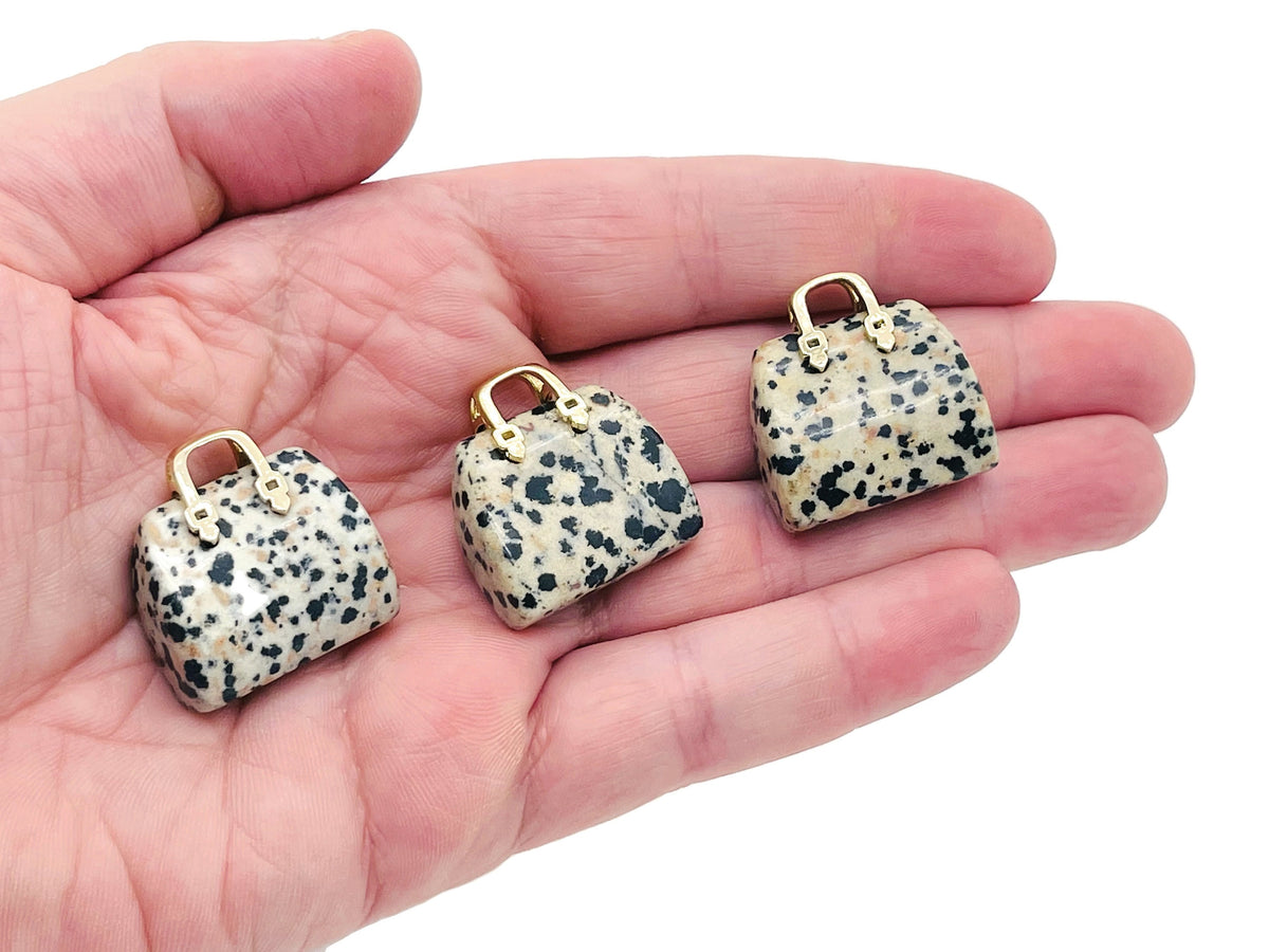 Dalmatian Jasper crystal purse carving gemstone with handbag pendant design, showcasing black spots and polished surface.