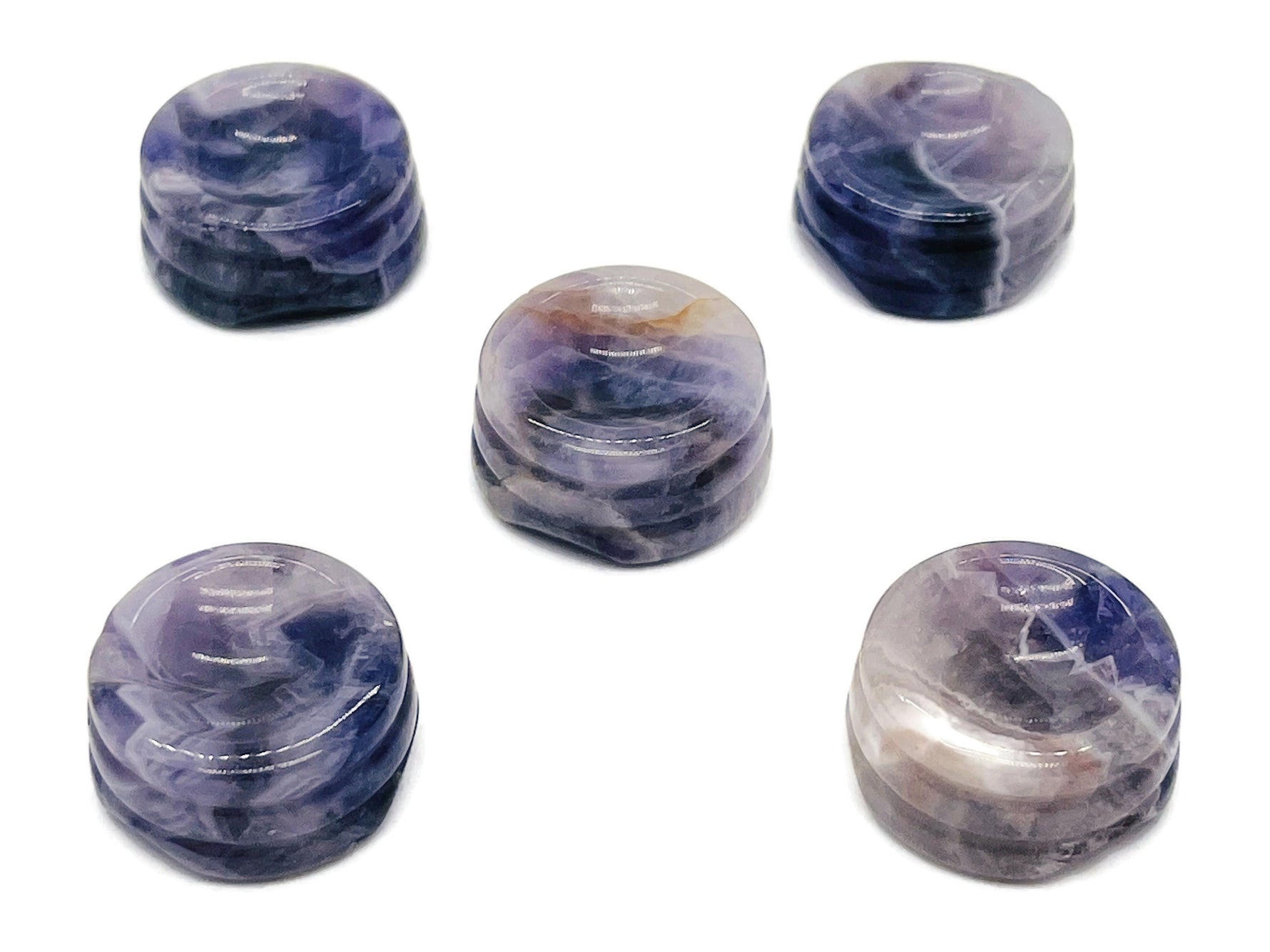Amethyst crystal sphere on carved gemstone stand, decorative home decor piece showcasing purple amethyst gemstone.