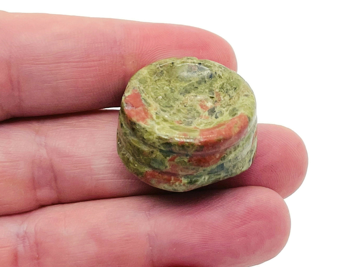 Unakite crystal sphere on carved gemstone stand, home decor decor piece showcasing vibrant green and pink mineral details.