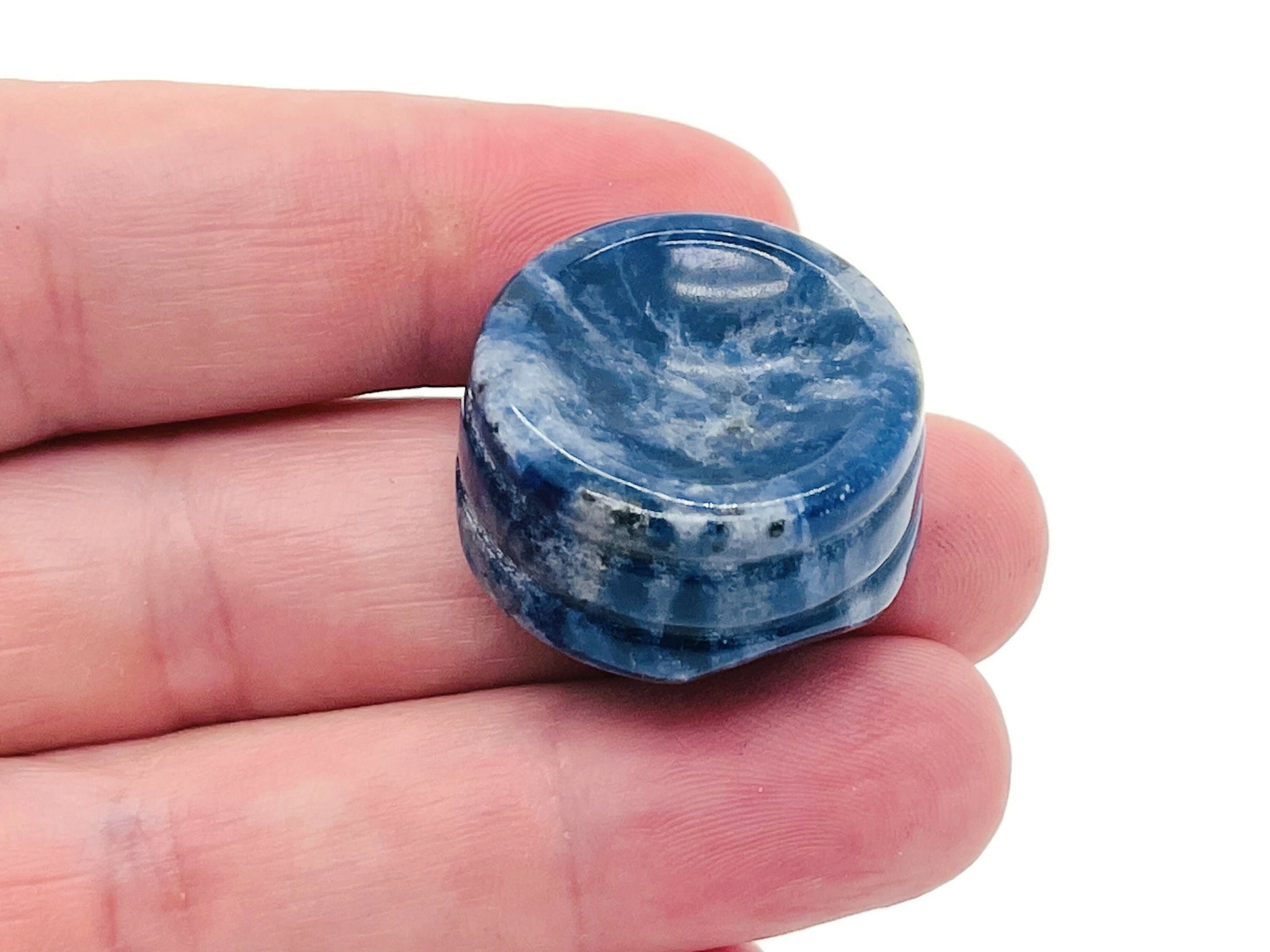 Sodalite crystal sphere on a carved gemstone stand, ideal for home decor and display.