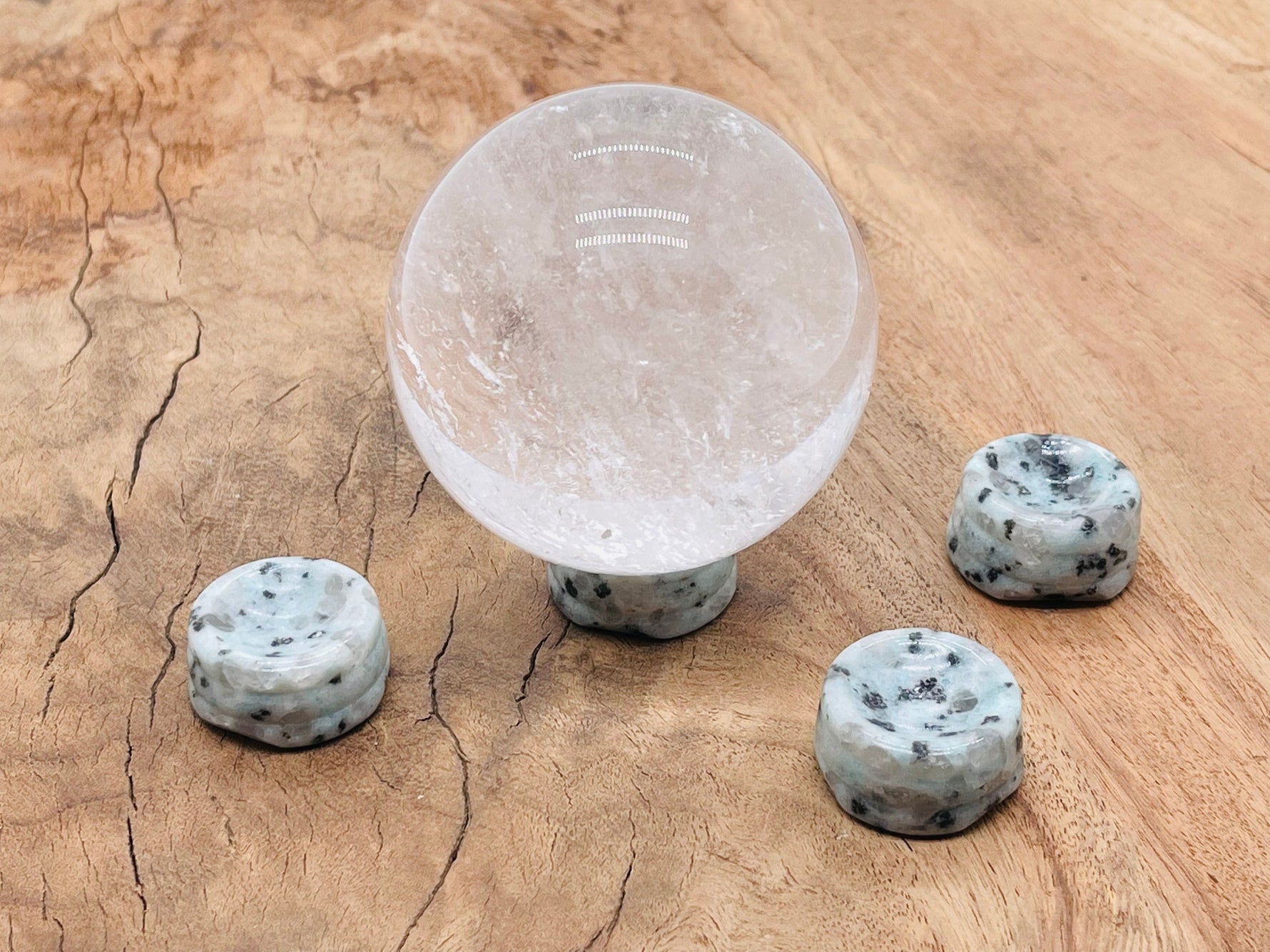 Kiwi Jasper crystal sphere on a carved gemstone stand, used as home decor, showcasing vibrant green and earthy tones.