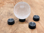 Larvikite crystal sphere on carved gemstone stand, used as elegant home decor piece by GemstoneGO.