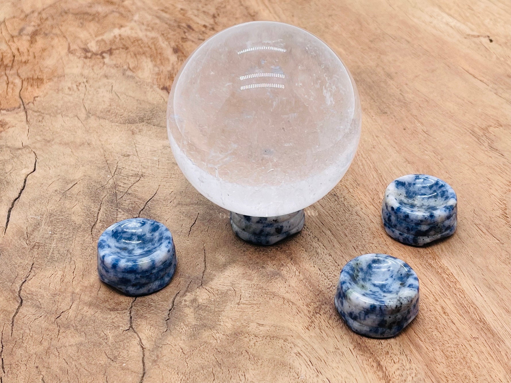 Blue Spot Jasper crystal sphere on carved gemstone stand, used as elegant home decor piece by GemstoneGO.