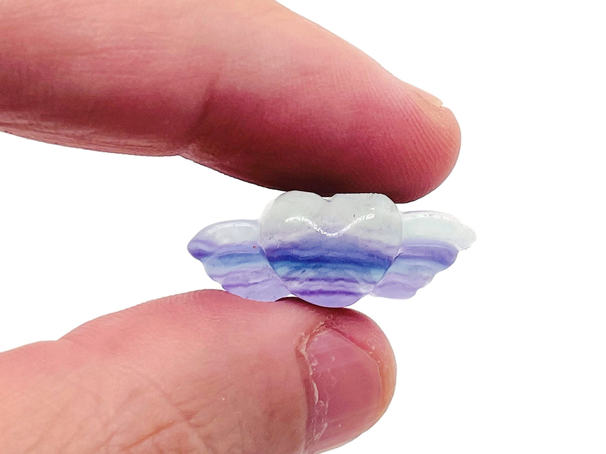 Fluorite wing heart gemstone carving by GemstoneGO, featuring vibrant green and purple hues with intricate wing and heart details.