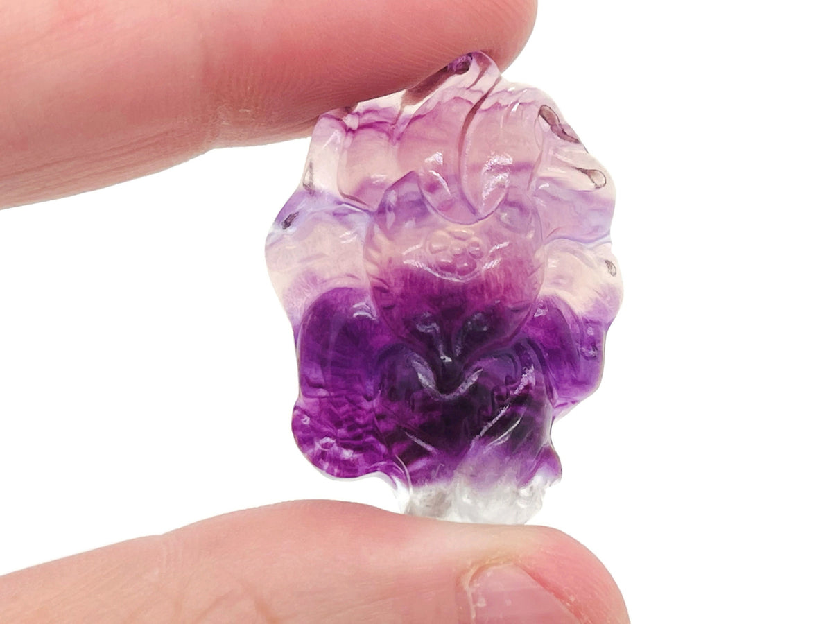 Colorful fluorite nine-tailed fox gemstone carving from GemstoneGO, detailed hand-carved fox figure with vibrant purple, green, and blue hues.