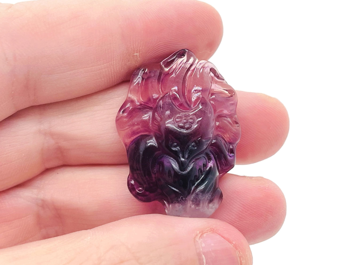 Fluorite nine-tailed fox gemstone carving by GemstoneGO, detailed multicolored stone sculpture on a neutral background.