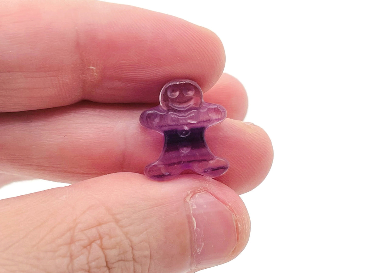 Fluorite gingerbread cookies carving gemstone from GemstoneGO showing vibrant green and purple hues with intricate carving details.