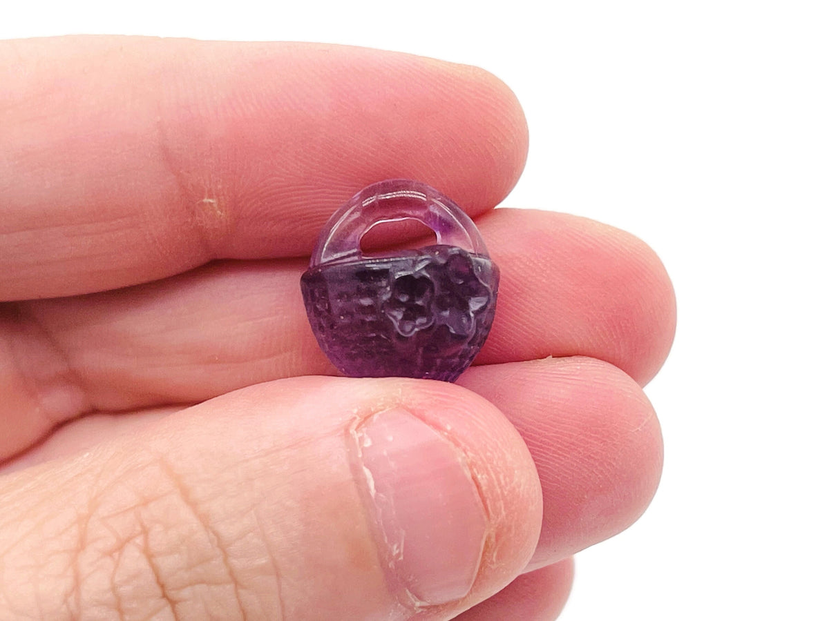 Colorful fluorite gemstone garden basket carving by GemstoneGO, showcasing intricate details and vibrant hues in a polished display.