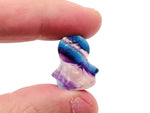 Fluorite angel kid gemstone carving by GemstoneGO, detailed purple and green mineral sculpture on a white background.