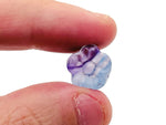 Small fluorite mini flower carving gemstone by GemstoneGO showing a vibrant purple and green floral design.