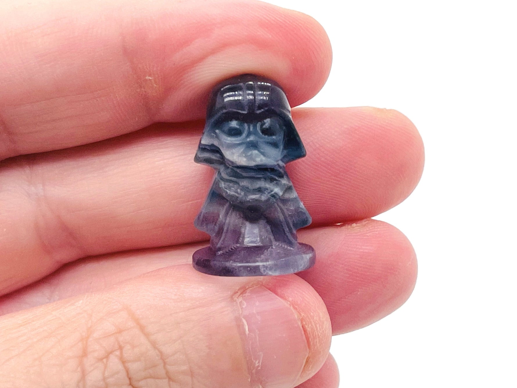 Fluorite Darth Vader carving gemstone from GemstoneGO, detailed dark purple and green mineral sculpture of Star Wars character.