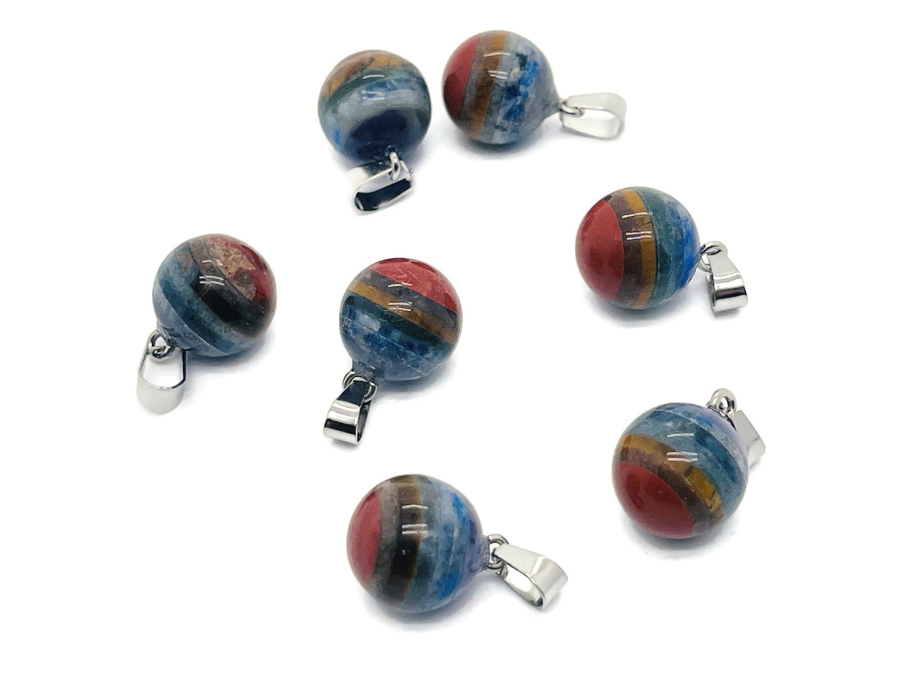 Chakra crystal pendant with seven stones from GemstoneGO, featuring a silver chain and vibrant multicolored chakra stones.