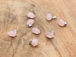 Rose quartz point crystal pendant from GemstoneGO, perfect for jewelry making, showcasing a polished pink quartz crystal on a string.