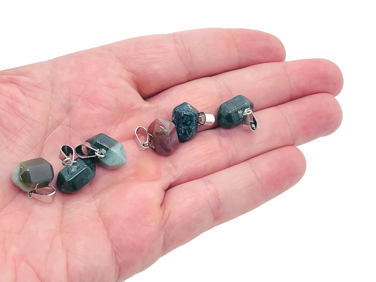 Moss agate point crystal pendant from GemstoneGO, used for jewelry making, showcasing a green and brown patterned gemstone on a string