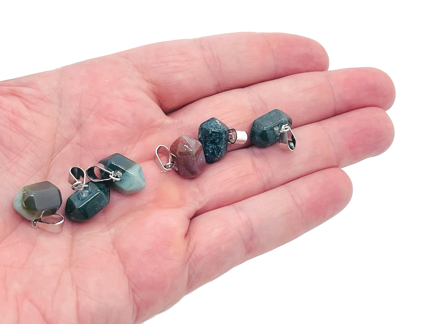 Moss agate point crystal pendant from GemstoneGO, used for jewelry making, showcasing a green and brown patterned gemstone on a string