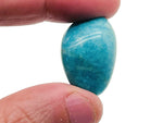 Amazonite tumbled stone by GemstoneGO, smooth blue-green gemstone with natural marbling, used for jewelry or healing practices.