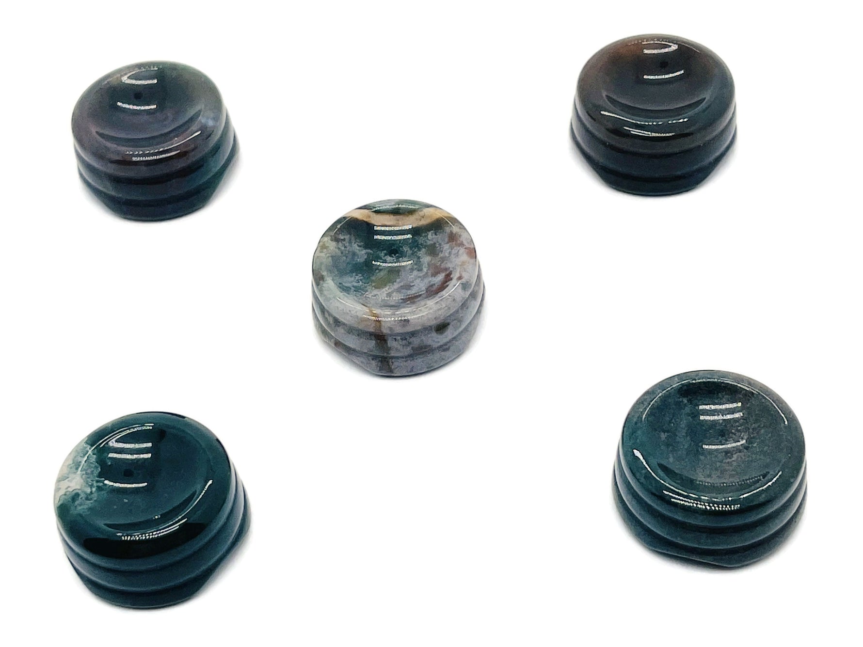 Moss agate crystal sphere on carved gemstone stand, decorative home decor piece showcasing natural stone patterns.
