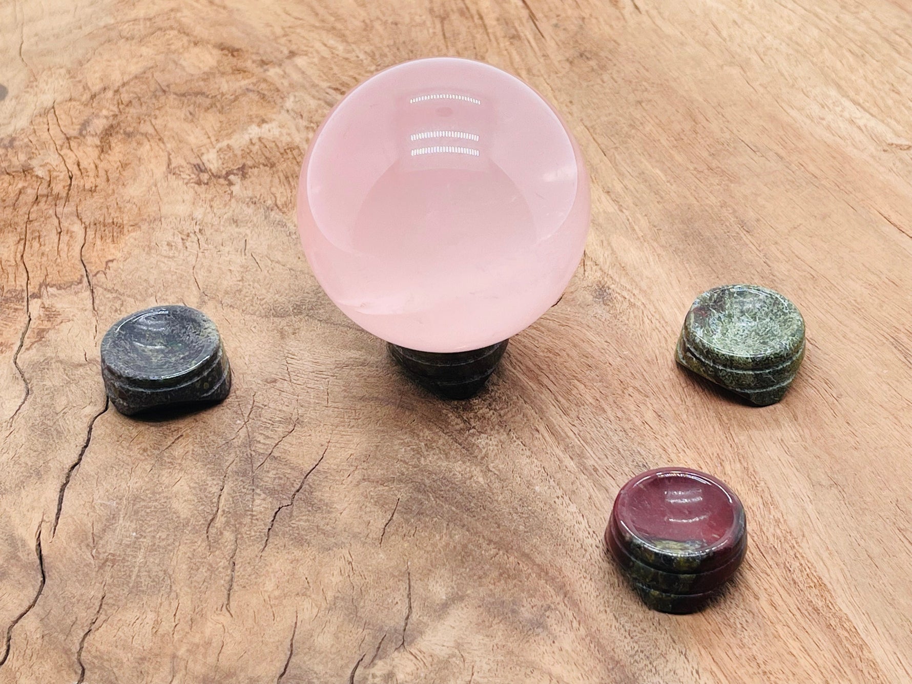 Dragon Blood Jasper crystal sphere on a carved gemstone stand, perfect for home decor and decorative displays.