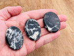 Zebra Calcite worry stone from GemstoneGO, smooth 4.5x3.5cm crystal with black and white striped pattern for soothing stress relief.