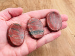 Red sesame jasper worry stone from GemstoneGO, soothing crystal, 4.5x3.5cm, polished and smooth for calming stress relief.
