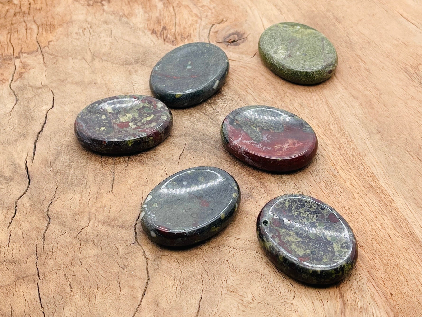 Dragon Blood Jasper worry stone from GemstoneGO, smooth 4.5x3.5cm crystal for stress relief and calming energy.