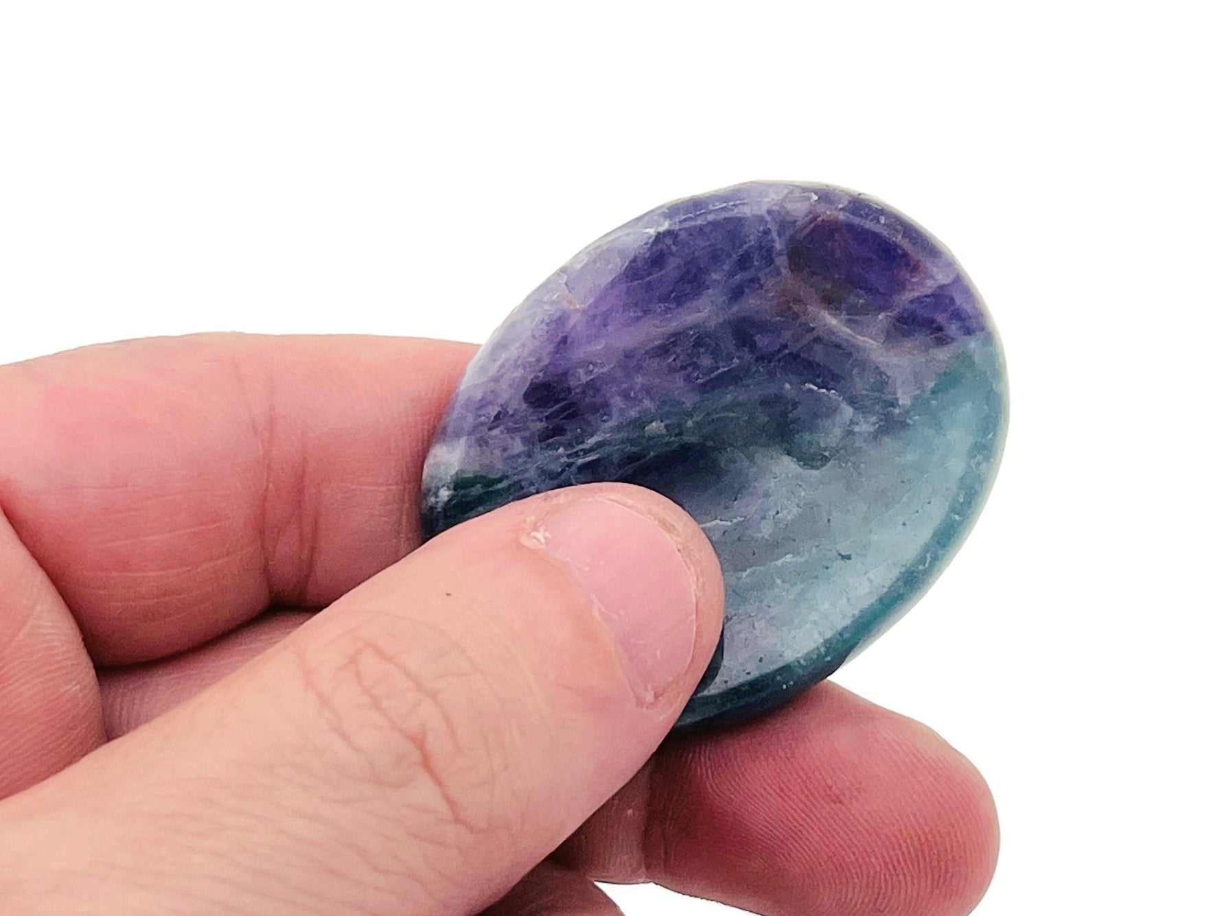 Fluorite worry stone from GemstoneGO, 4.5x3.5cm soothing crystal with polished surface and vibrant green and purple hues.