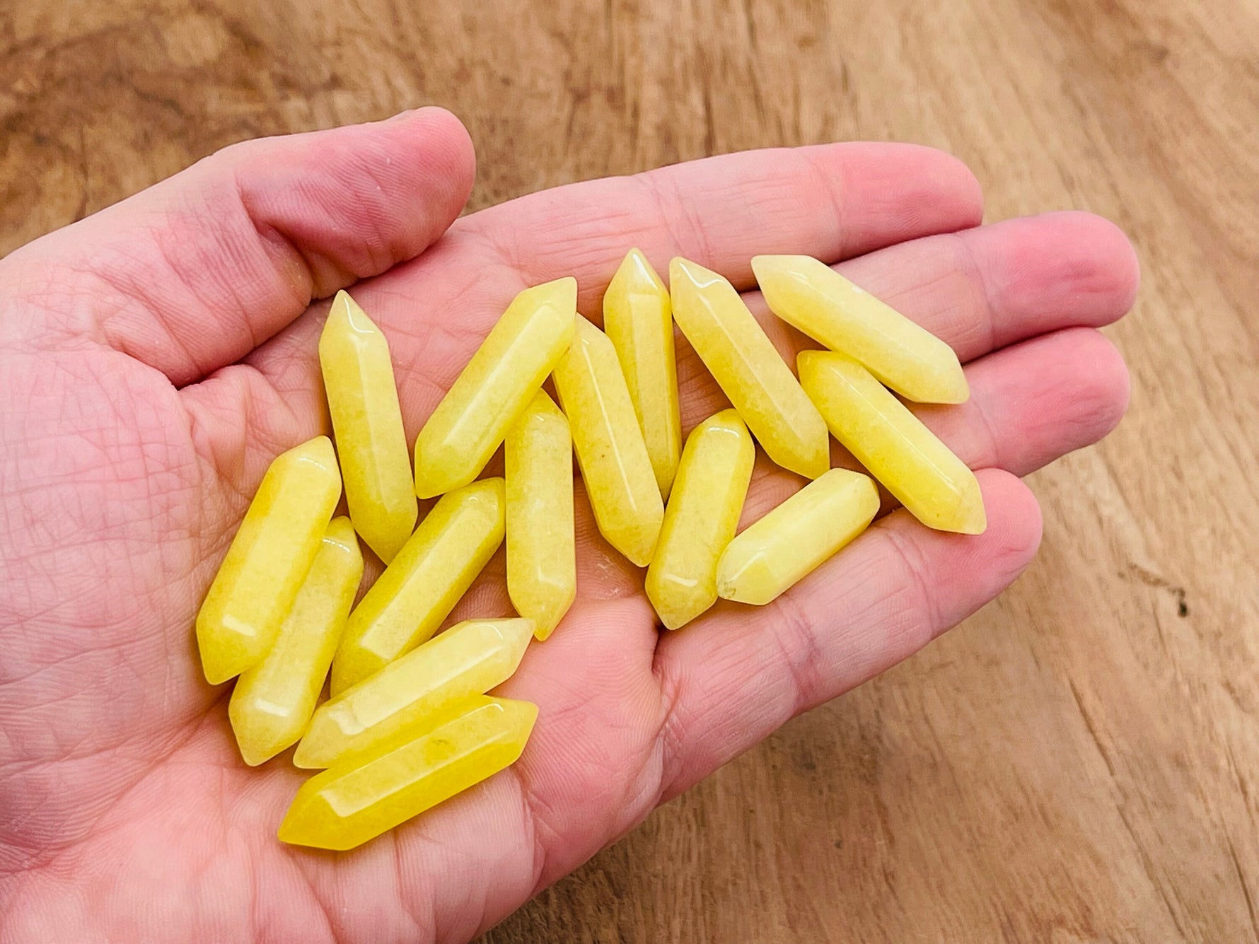 Lemon Jade Terminated Carved Point gemstone, 33mm, from GemstoneGO, showing smooth carved surface and natural yellow-green color.