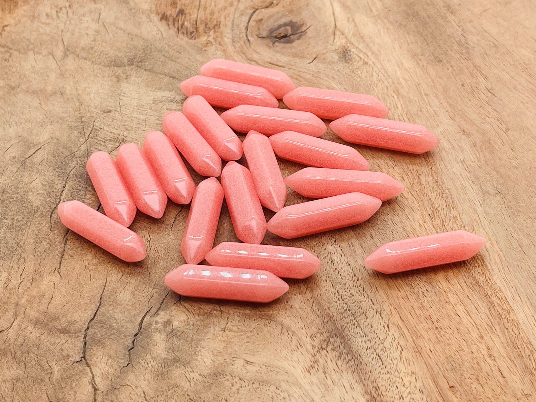 Red luminous carved gemstone point, 33mm length, with intricate carved design, from GemstoneGO.