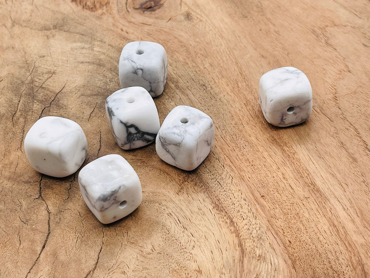 Handmade Howlite crystal incense holder with carved design, designed to hold incense sticks securely for aromatic burning.