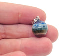 Chakra crystal pendant with seven stones from GemstoneGO, featuring a silver bail and vibrant, multicolored gemstones.