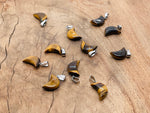 Tiger Eye moon-shaped crystal pendant from GemstoneGO, ideal for jewelry making, showcasing a polished, warm-toned gemstone design.