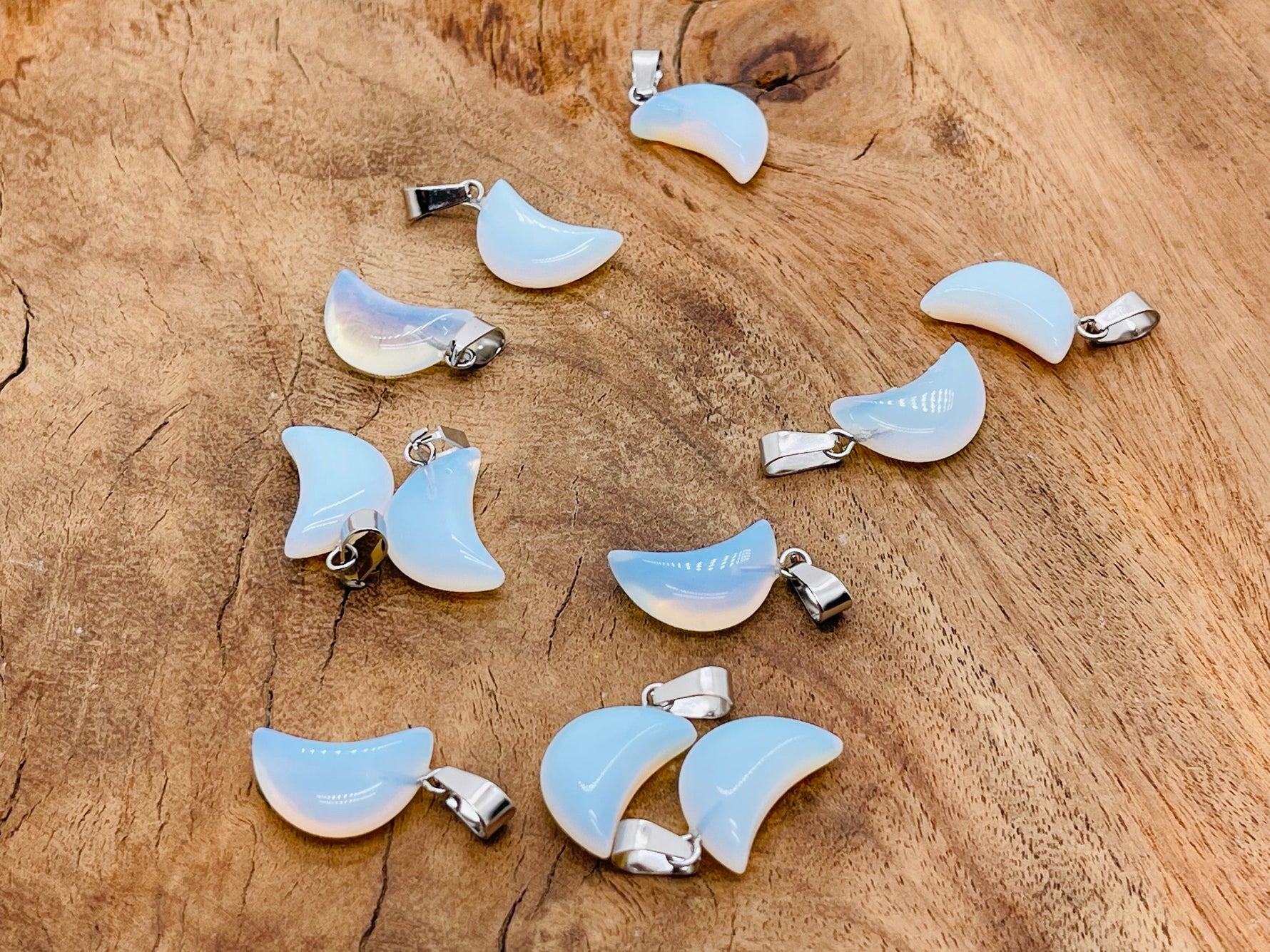 Opalite moon crystal pendant from GemstoneGO, smooth polished jewelry making supply with a luminous, moon-shaped design.