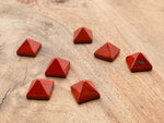 Red Jasper pyramid gemstone carving, 14mm, from GemstoneGO, showcasing a polished red stone pyramid with natural gemstone details.