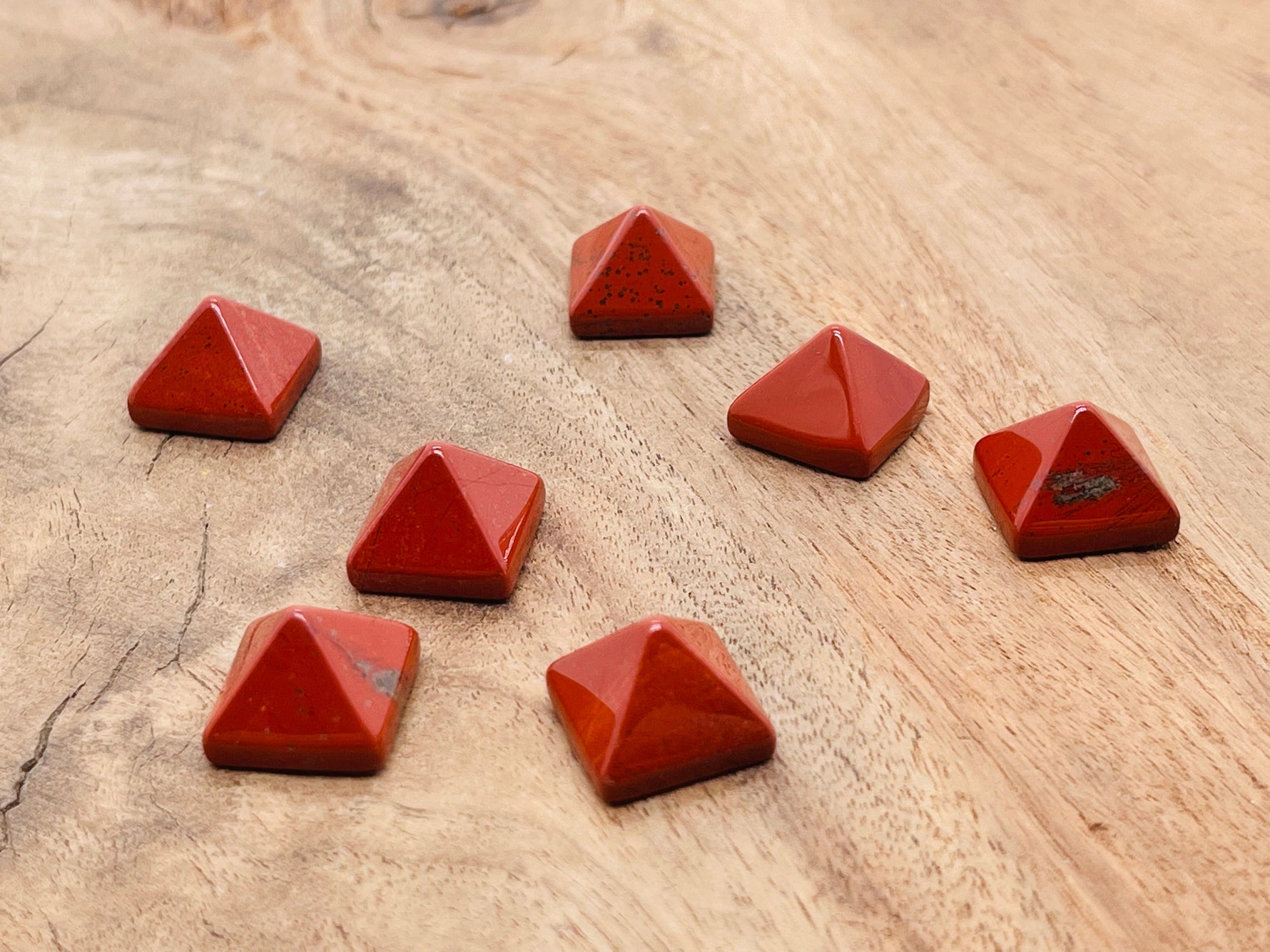 Red Jasper pyramid gemstone carving, 14mm, from GemstoneGO, showcasing a polished red stone pyramid with natural gemstone details.