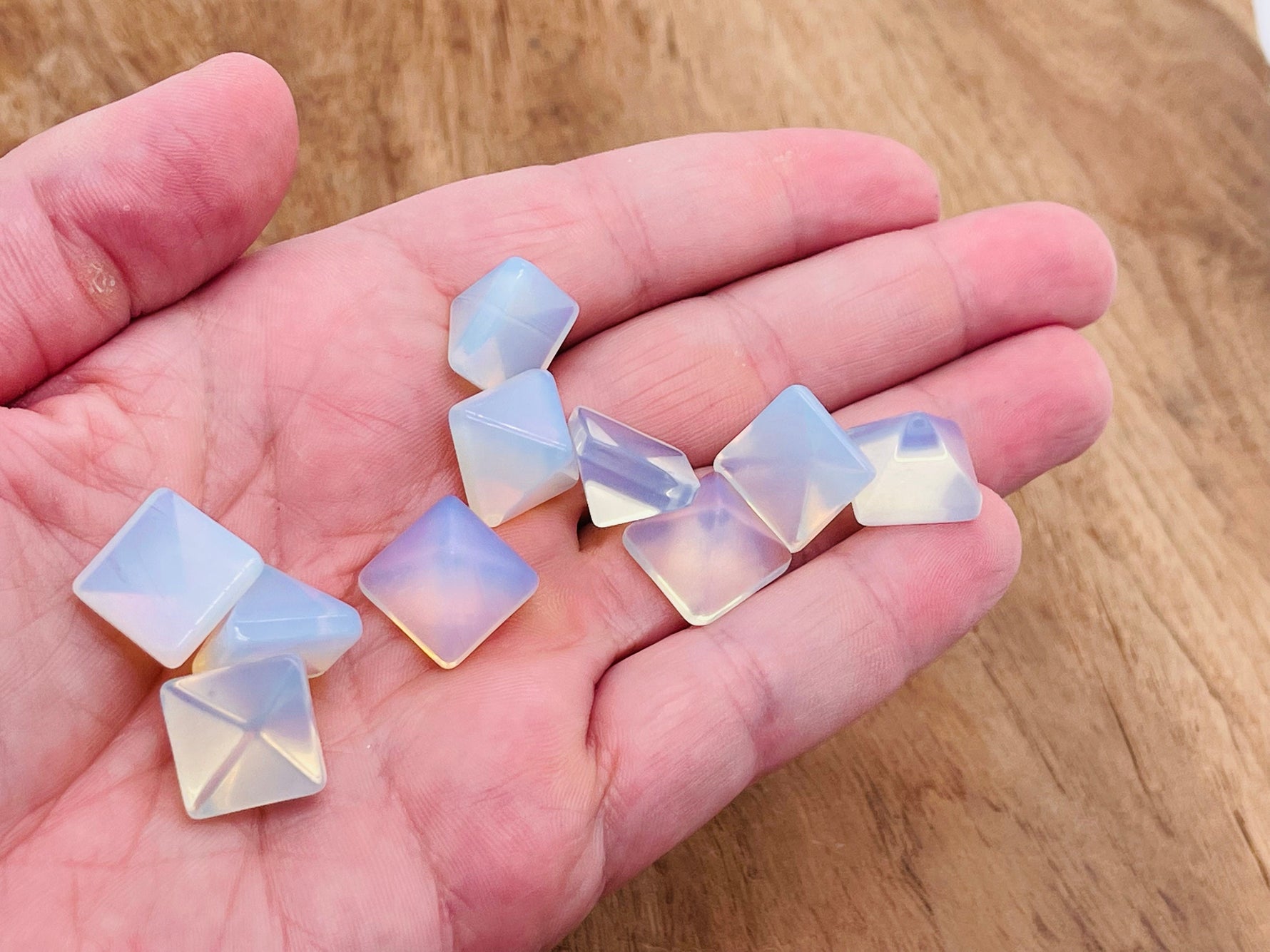 Opalite gemstone pyramid carving, 14mm size, showcasing smooth, reflective surface and pyramid shape from GemstoneGO.