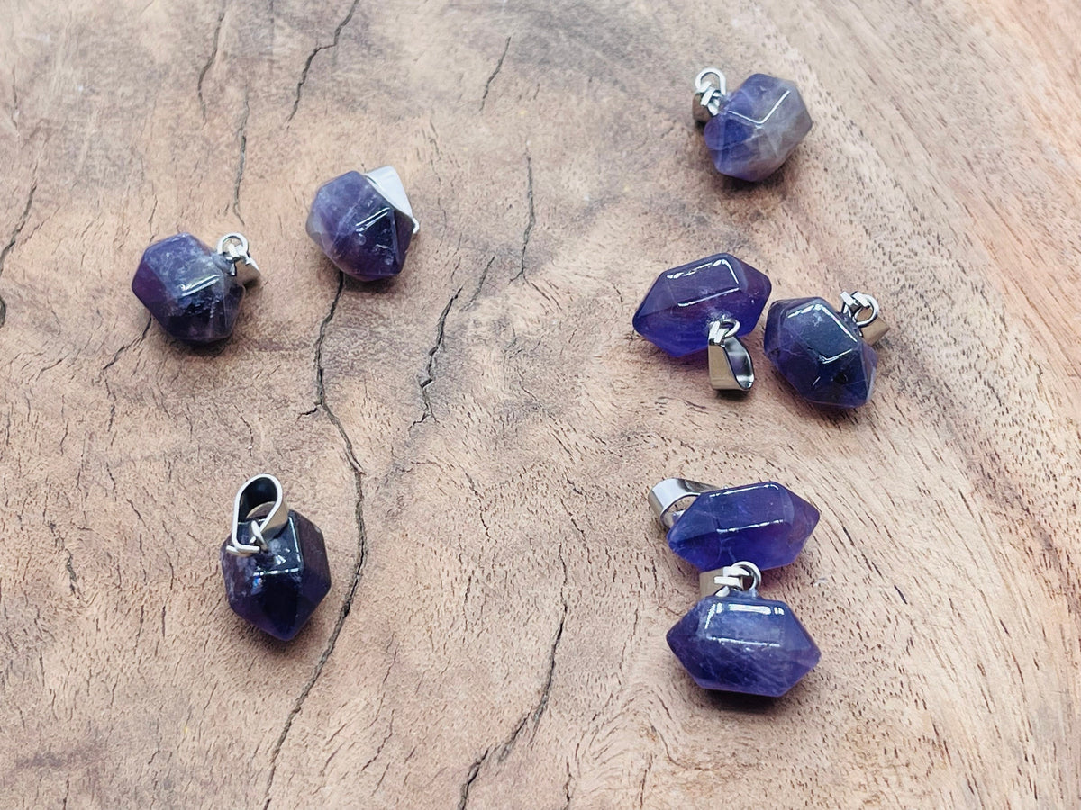 Amethyst point crystal pendant from GemstoneGO, showcasing a purple gemstone with a pointed tip, perfect for jewelry making supplies.