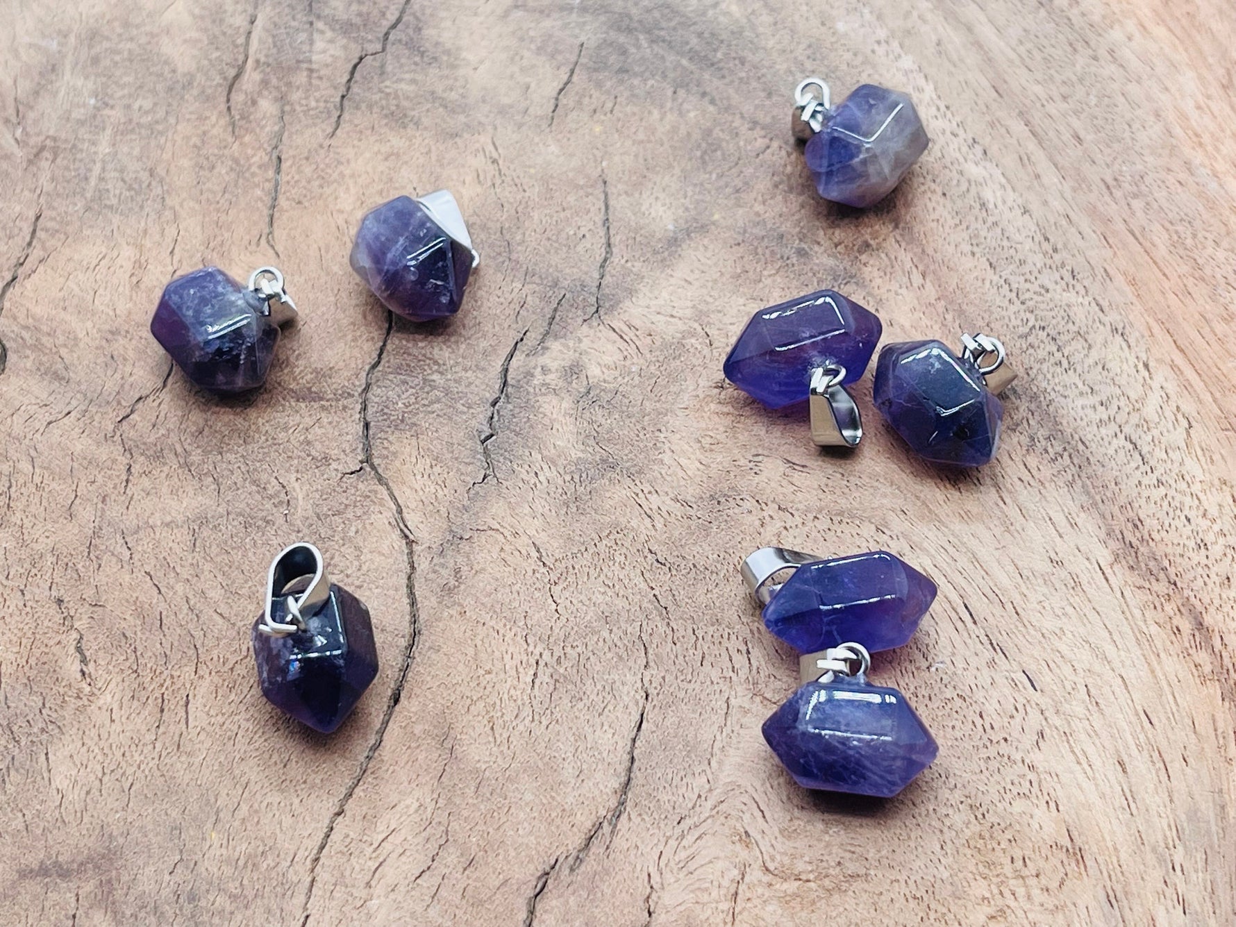 Amethyst point crystal pendant from GemstoneGO, showcasing a purple gemstone with a pointed tip, perfect for jewelry making supplies.