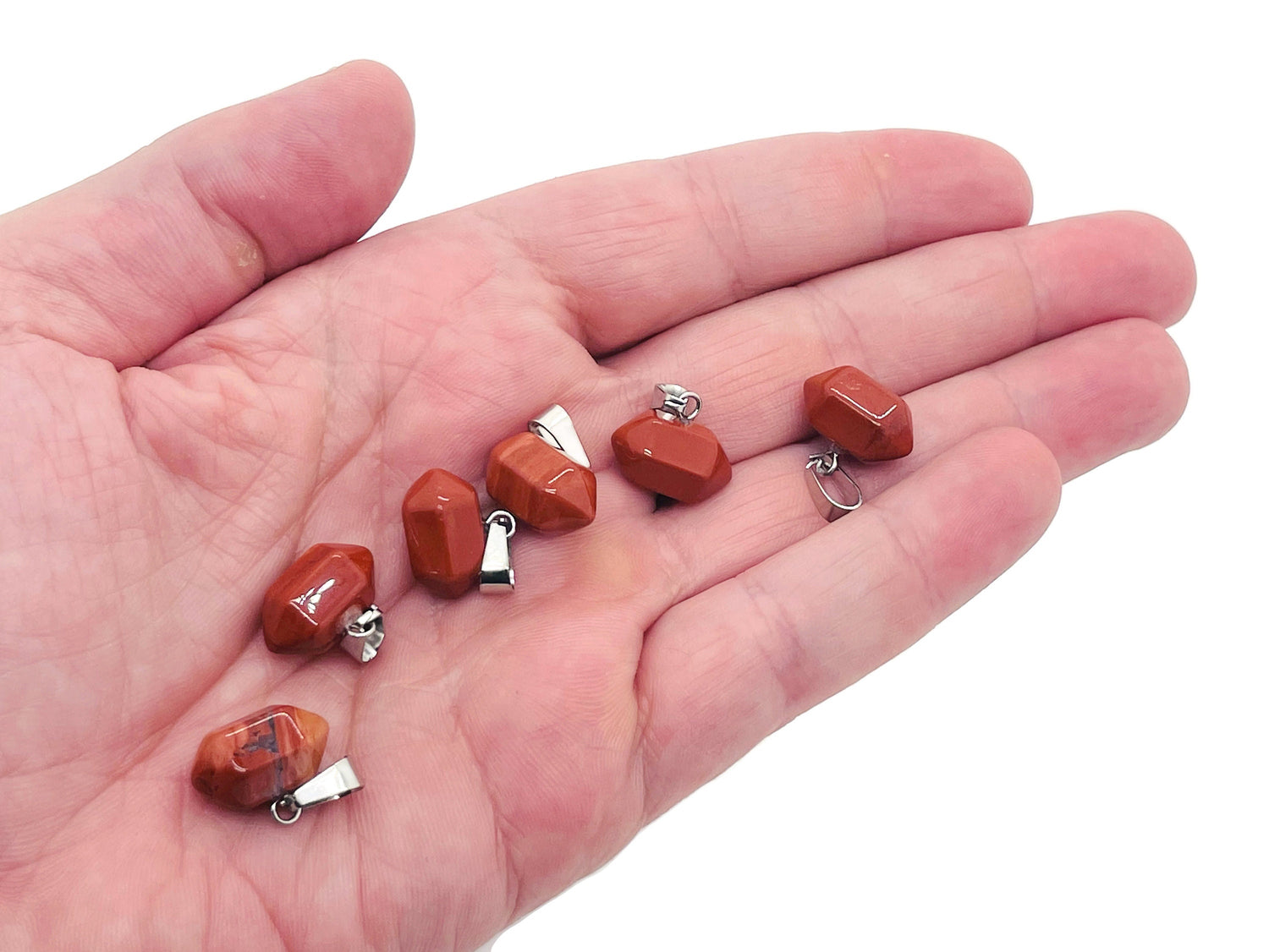 Red Jasper point crystal pendant from GemstoneGO, showcasing a polished red jasper stone with natural banding and pointed shape for jewelry making.