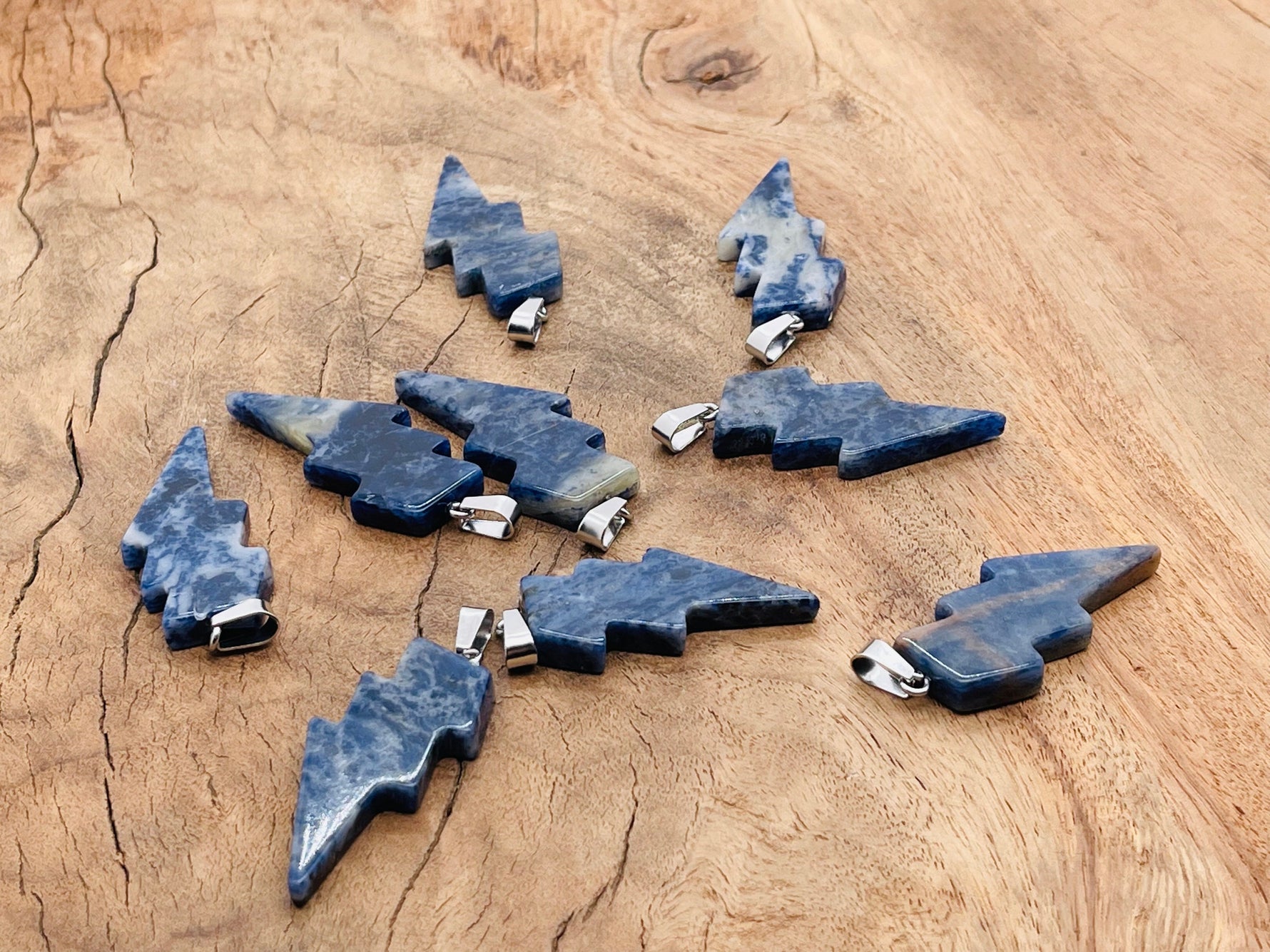 Sodalite lightning crystal pendant from GemstoneGO featuring a deep blue and white lightning stone pendant on a silver chain.