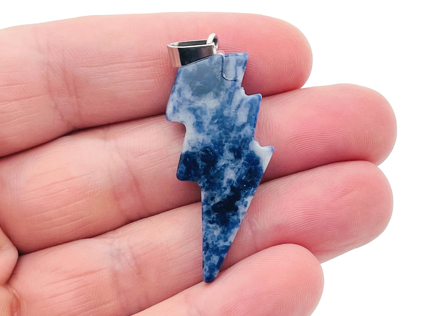 Sodalite Lightning Crystal Pendant by GemstoneGO featuring a vibrant blue lightning stone pendant with natural crystal details.
