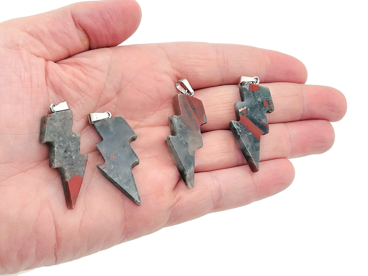 African Bloodstone Lightning Crystal Pendant featuring a striking lightning-shaped bloodstone gemstone on a silver chain.