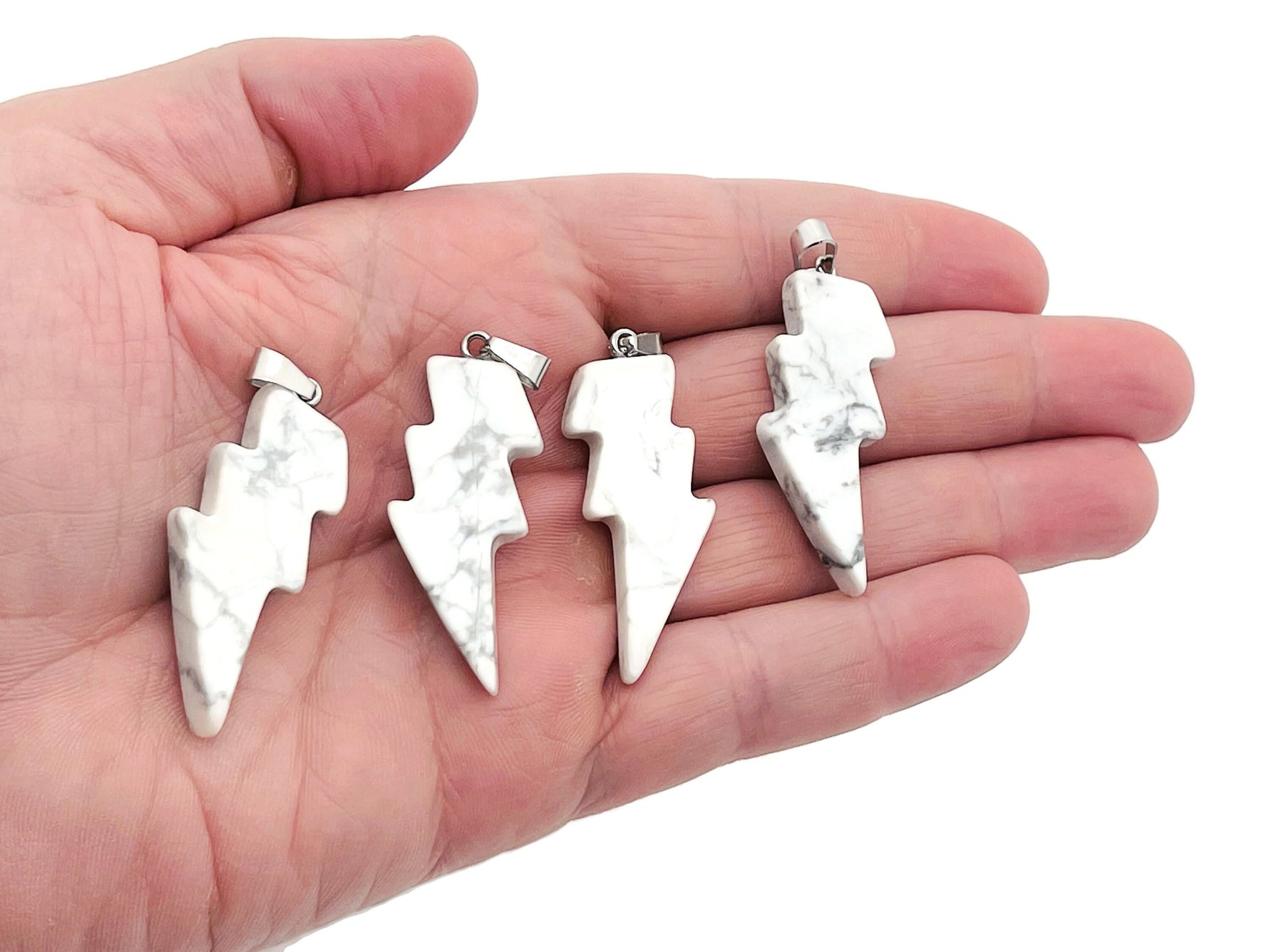 Howlite Lightning Crystal Pendant from GemstoneGO featuring a striking lightning-shaped stone on a silver chain.