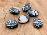 Zebra Calcite palm gemstone spa stone, 45x35mm, smooth polished natural mineral with distinctive black and white striped pattern.